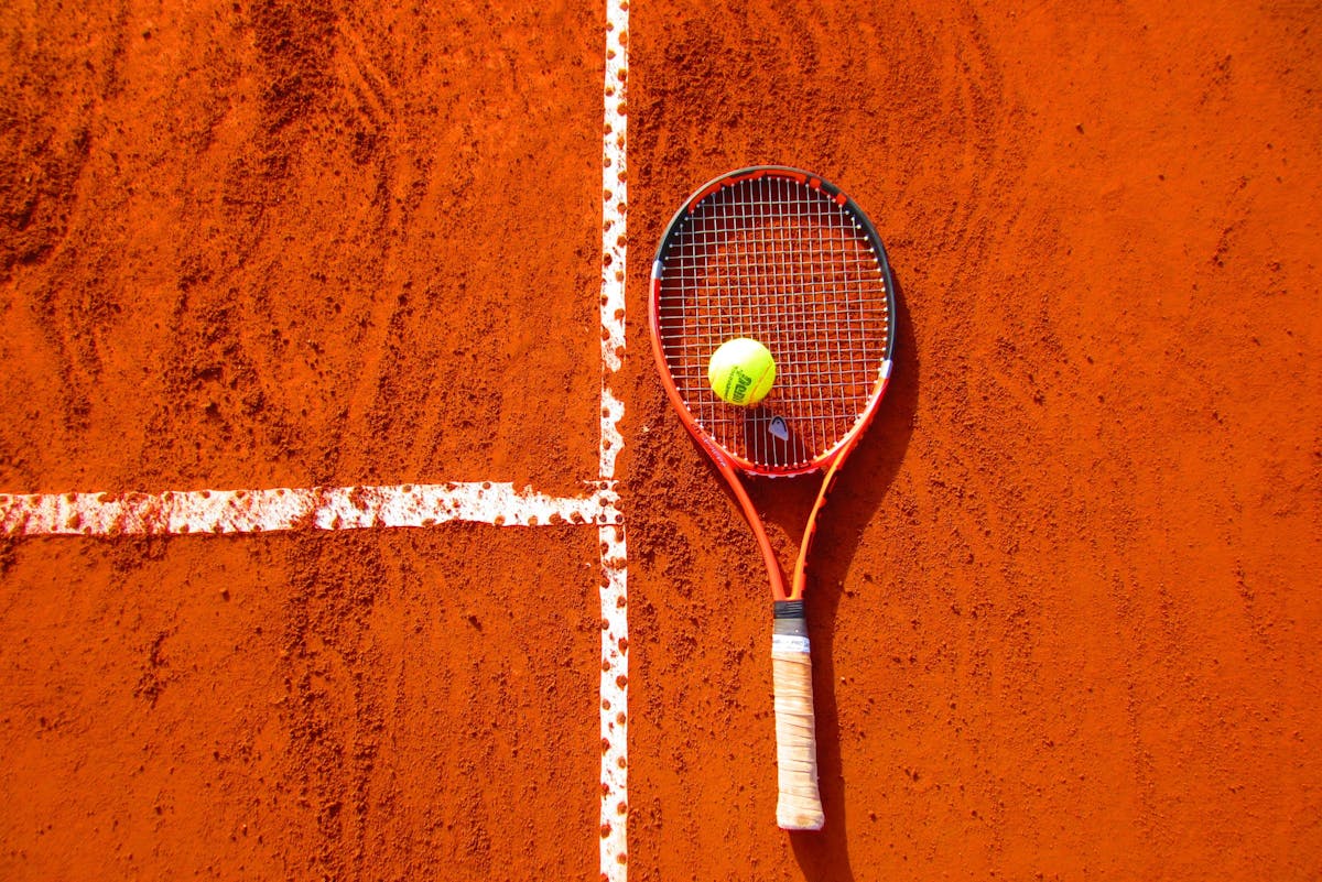 Elite tennis athlete preparing for a return on center court