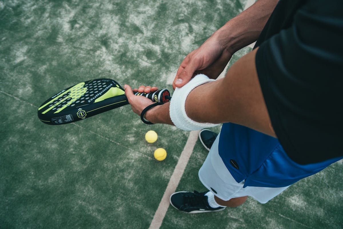 Tennis ball on court under stadium lights at night